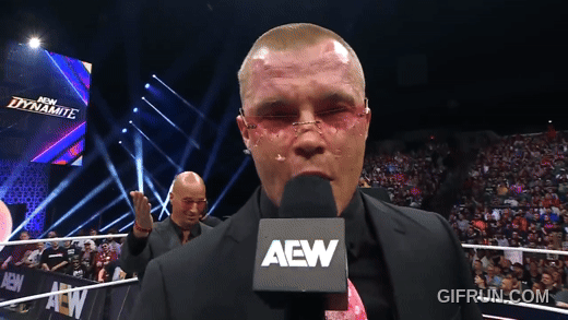 Don_Callis_gives_Kyle_Fletcher_art_to_celebrate_his_TNT_Cham (1).gif