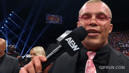 Don_Callis_gives_Kyle_Fletcher_art_to_celebrate_his_TNT_Cham.gif