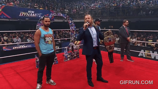 Kenny_Omega_gets_his_NEW_AEW_World_Championship_from_Young_B (7).gif