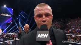 Don_Callis_gives_Kyle_Fletcher_art_to_celebrate_his_TNT_Cham (1).gif