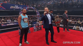 Kenny_Omega_gets_his_NEW_AEW_World_Championship_from_Young_B (7).gif