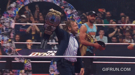 Kenny_Omega_gets_his_NEW_AEW_World_Championship_from_Young_B.gif